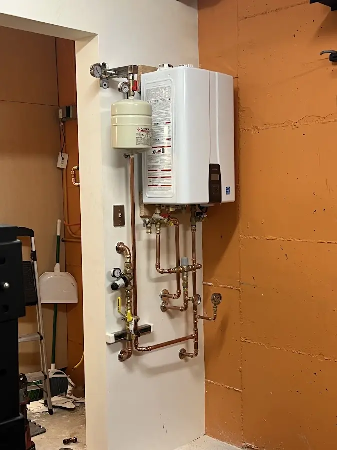 Plumbing technician inspecting water heater connections in North Bethesda